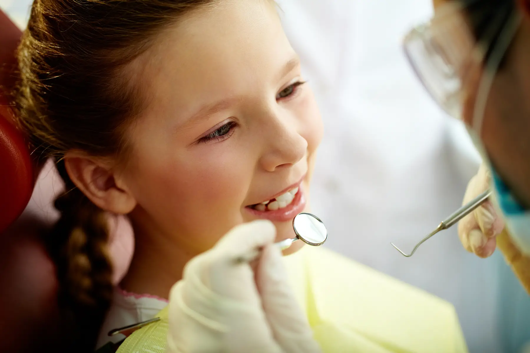 Young girl receiving dental treatment
