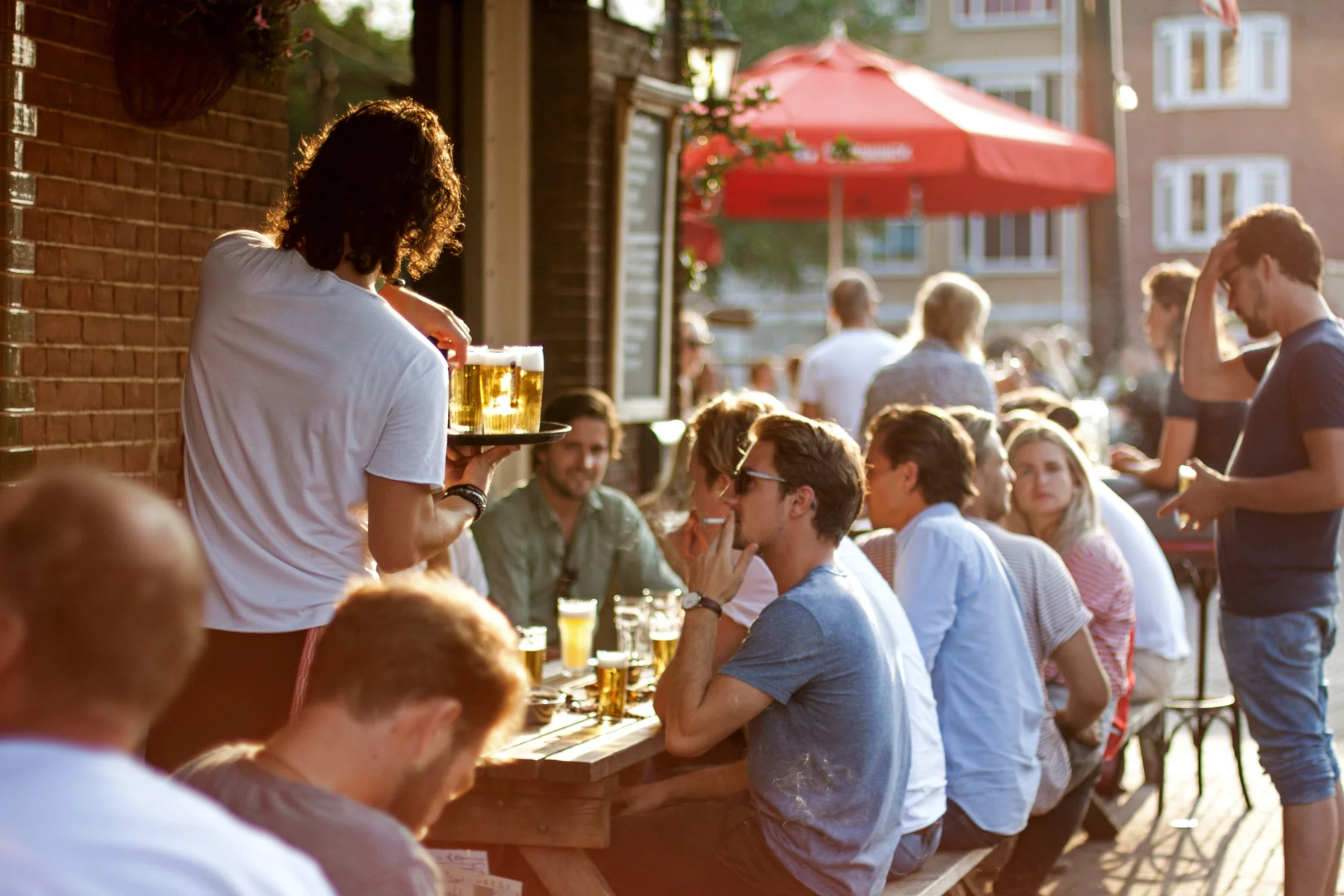 A group meeting for drinks on an outdoor terrace