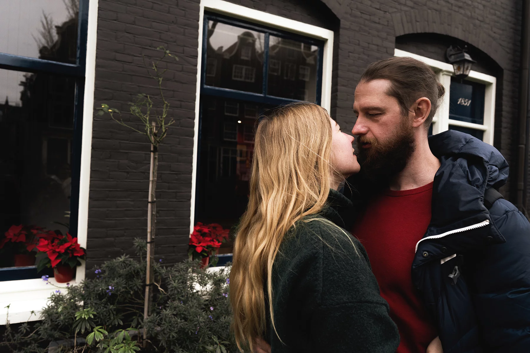 Intimate couple in front of their house in Amsterdam
