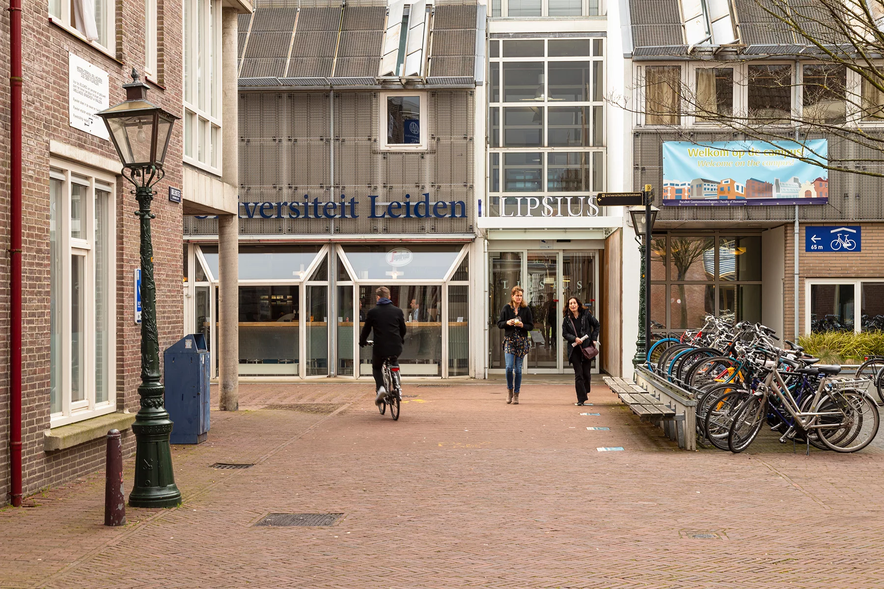 Two students outside the grey Lipsius building in at Leiden University, the Netherlands