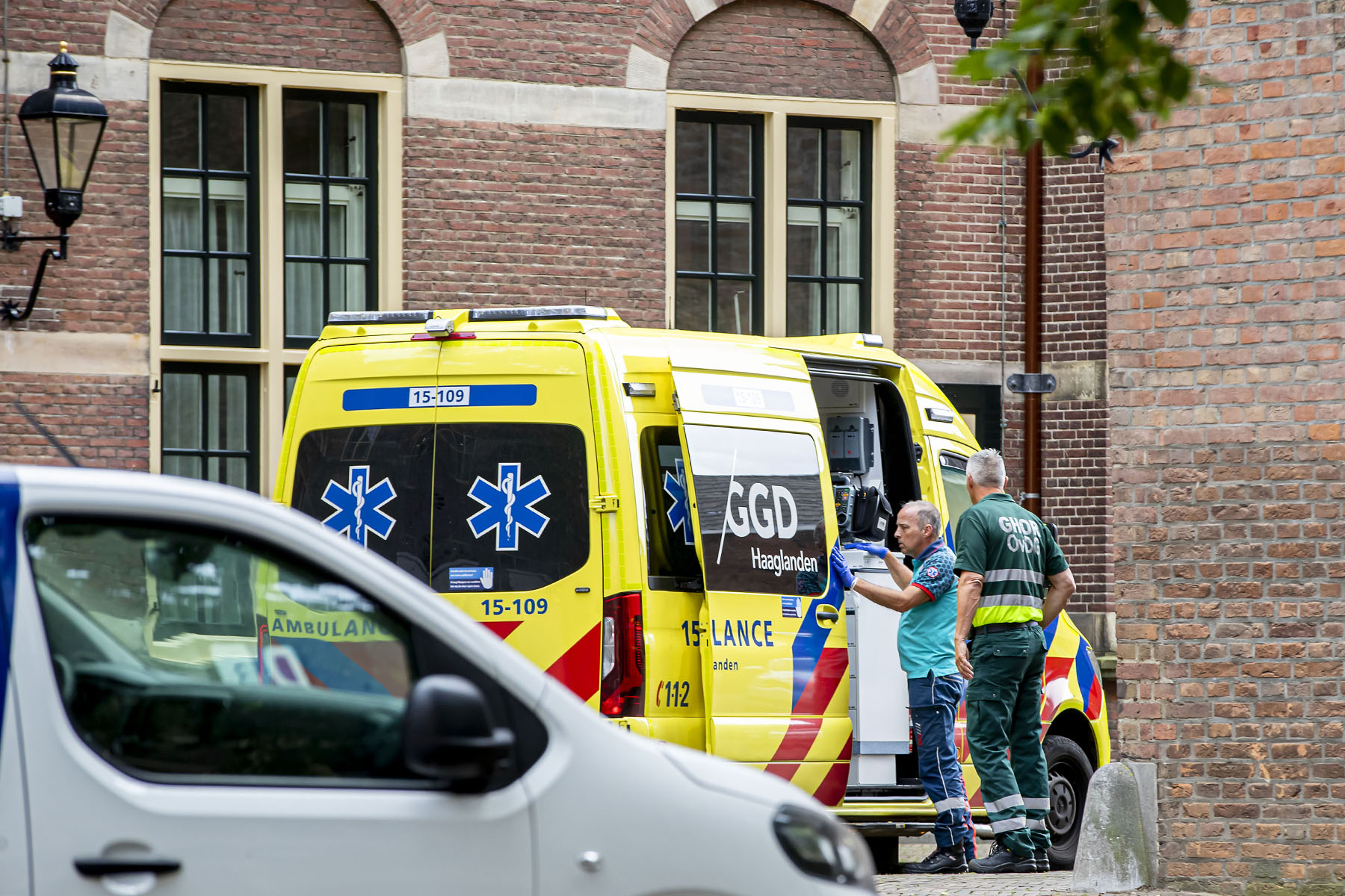 Two ambulance workers standing by an ambulance in The Hague, the Netherlands.