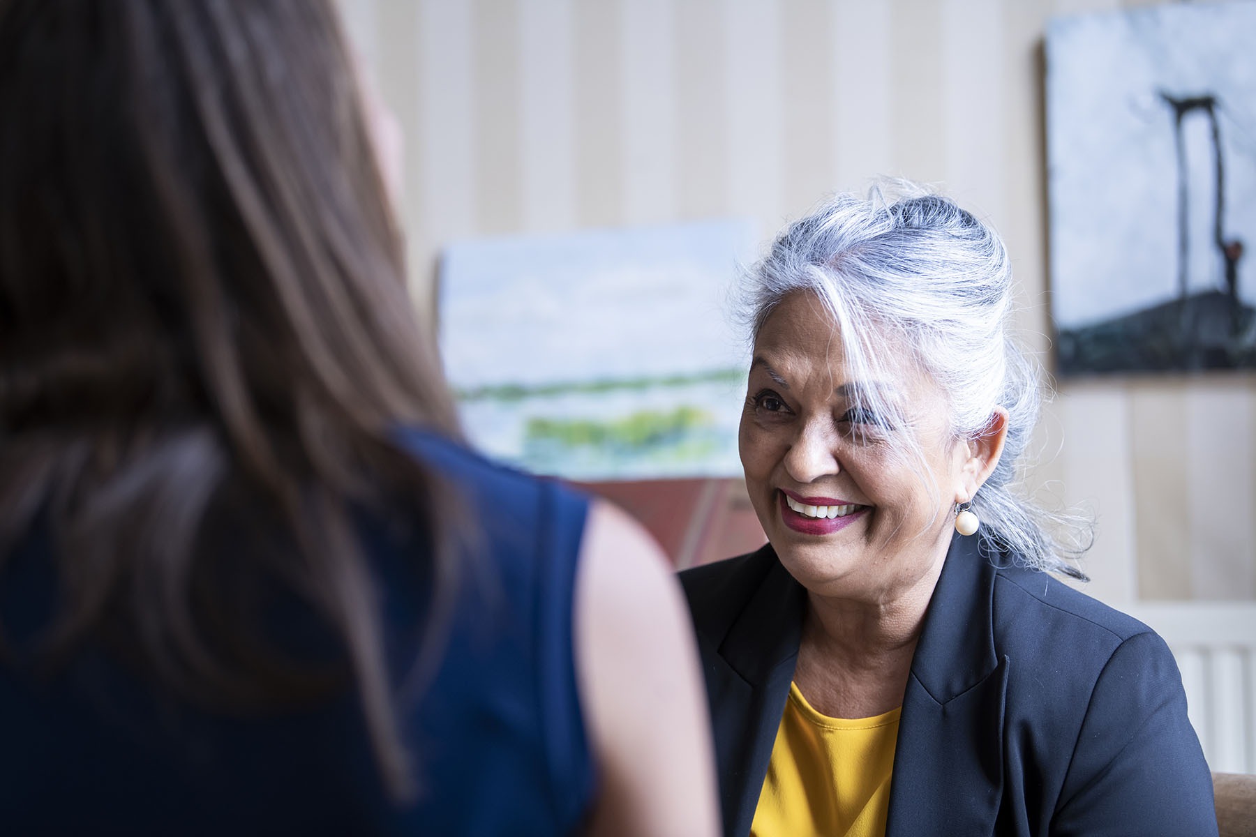Older woman is smiling during a job interview.