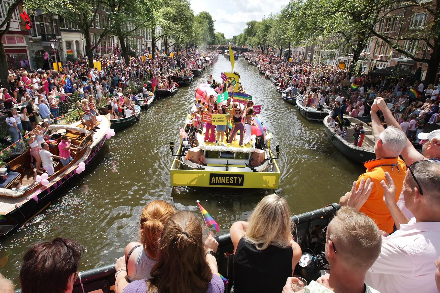 Boats on the canal during Pride Amsterdam 2022. Big crowds.