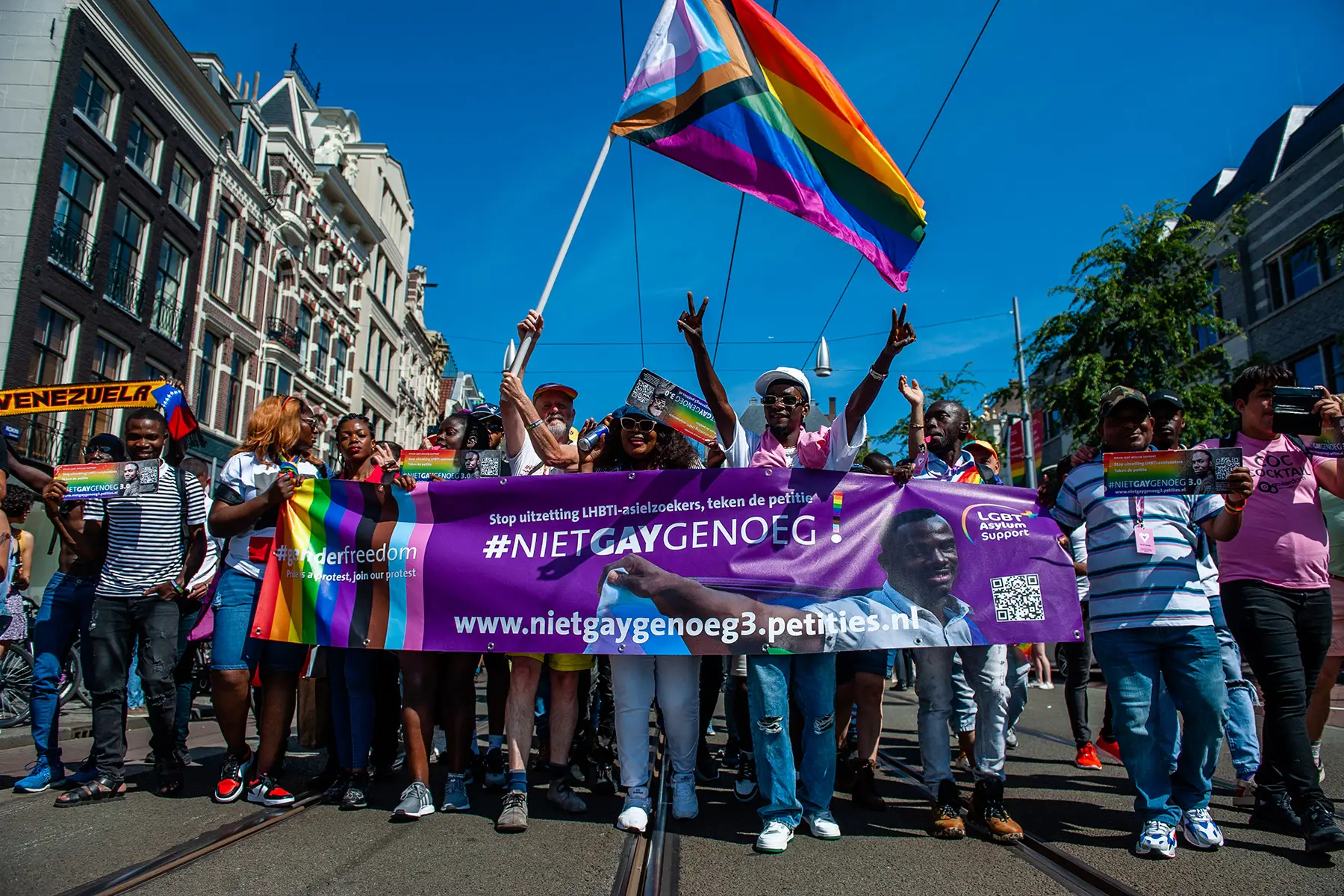 Protesters with a banner that says #NietGayGenoeg (not gay enough)