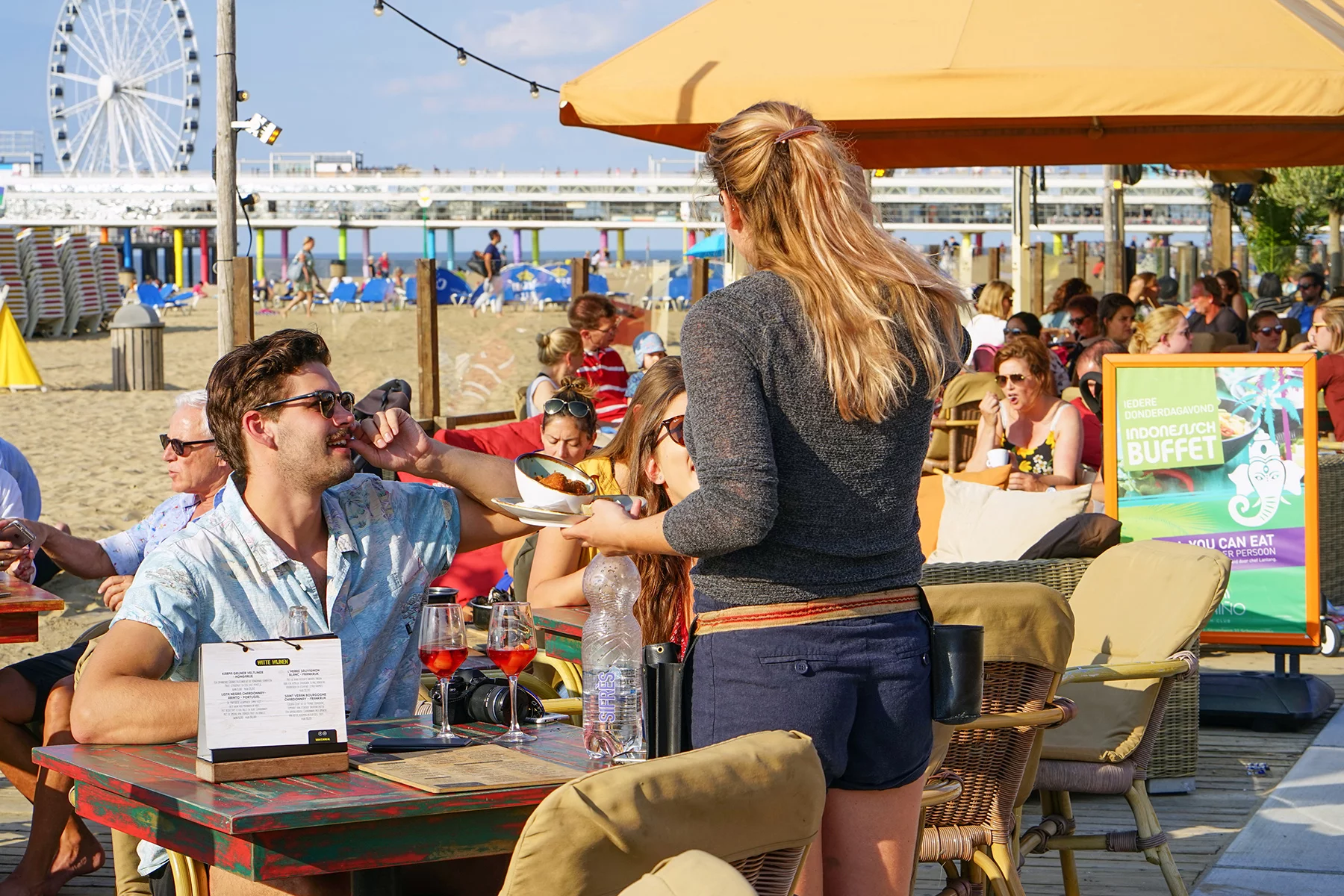 Customers order at a beach bar in Scheveningen