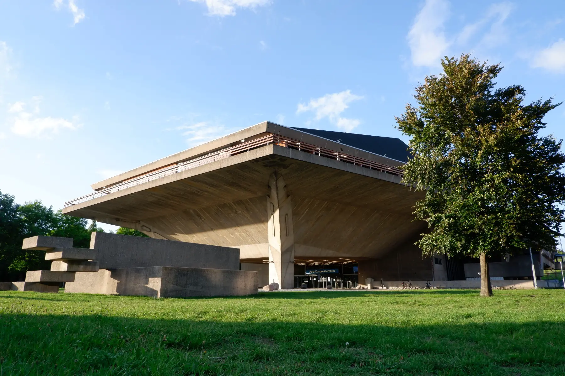 Modern concrete building at TU Delft, like an upside-down pyramid.