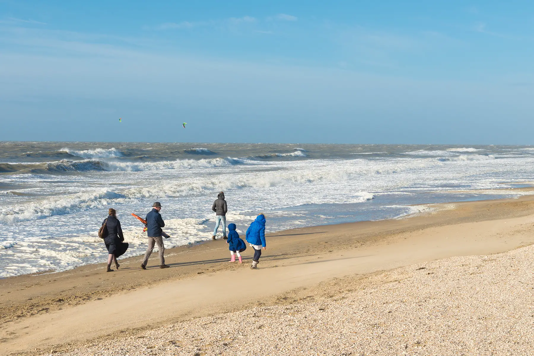 A family walking on the beach in The Hague