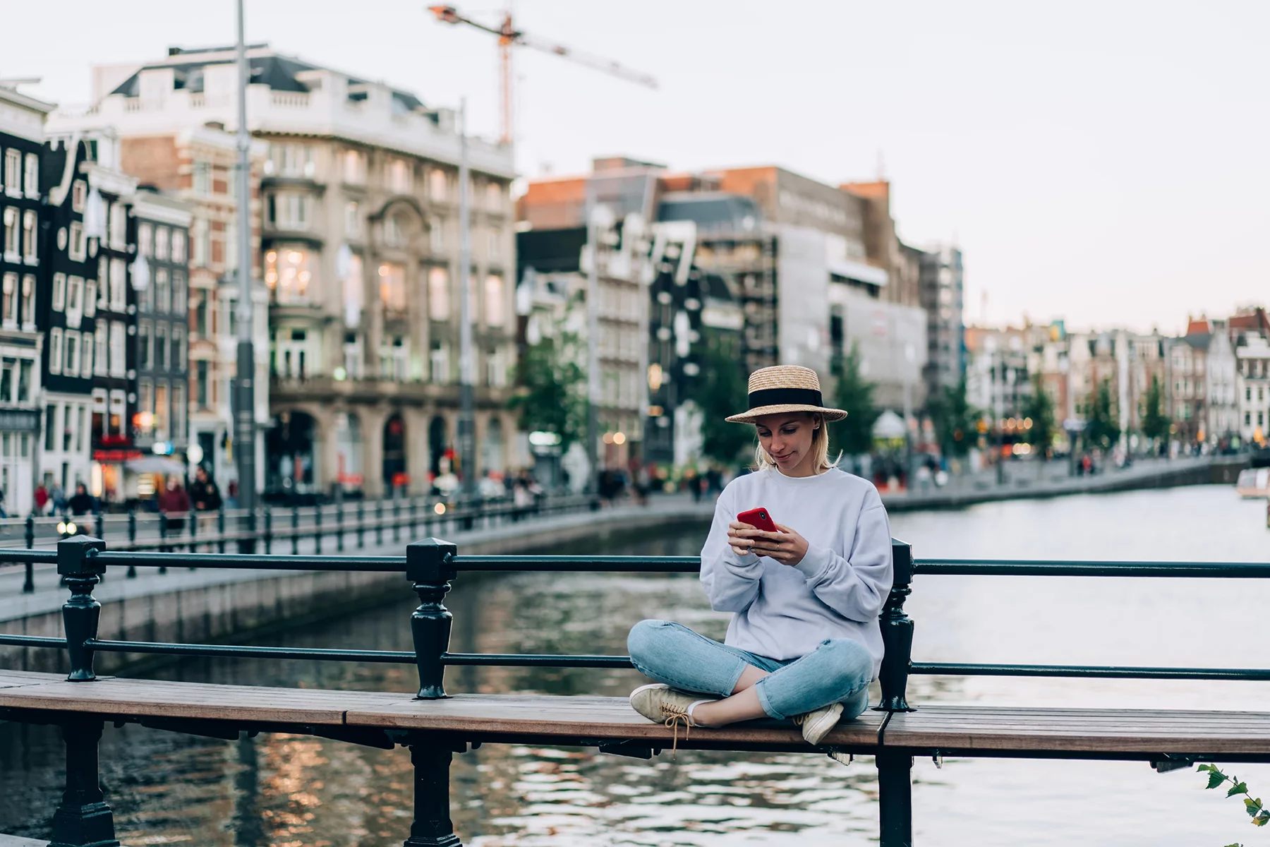 Woman using her phone in Amsterdam, the Netherlands