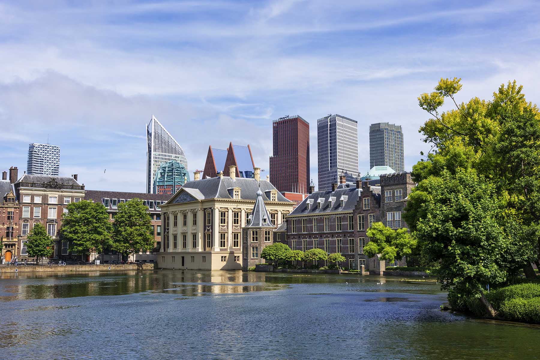 View of the Dutch Parliament (Binnenhof), surrounded by water and the highrise buildings of The Hague in the background