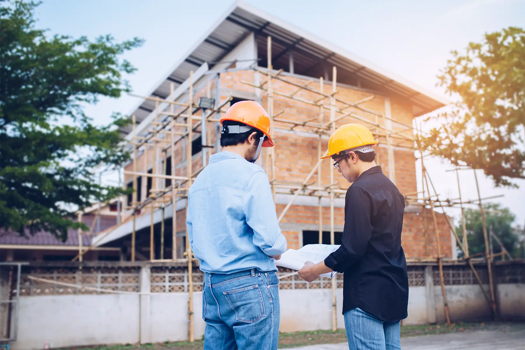 two engineers discussing a building project on a construction site