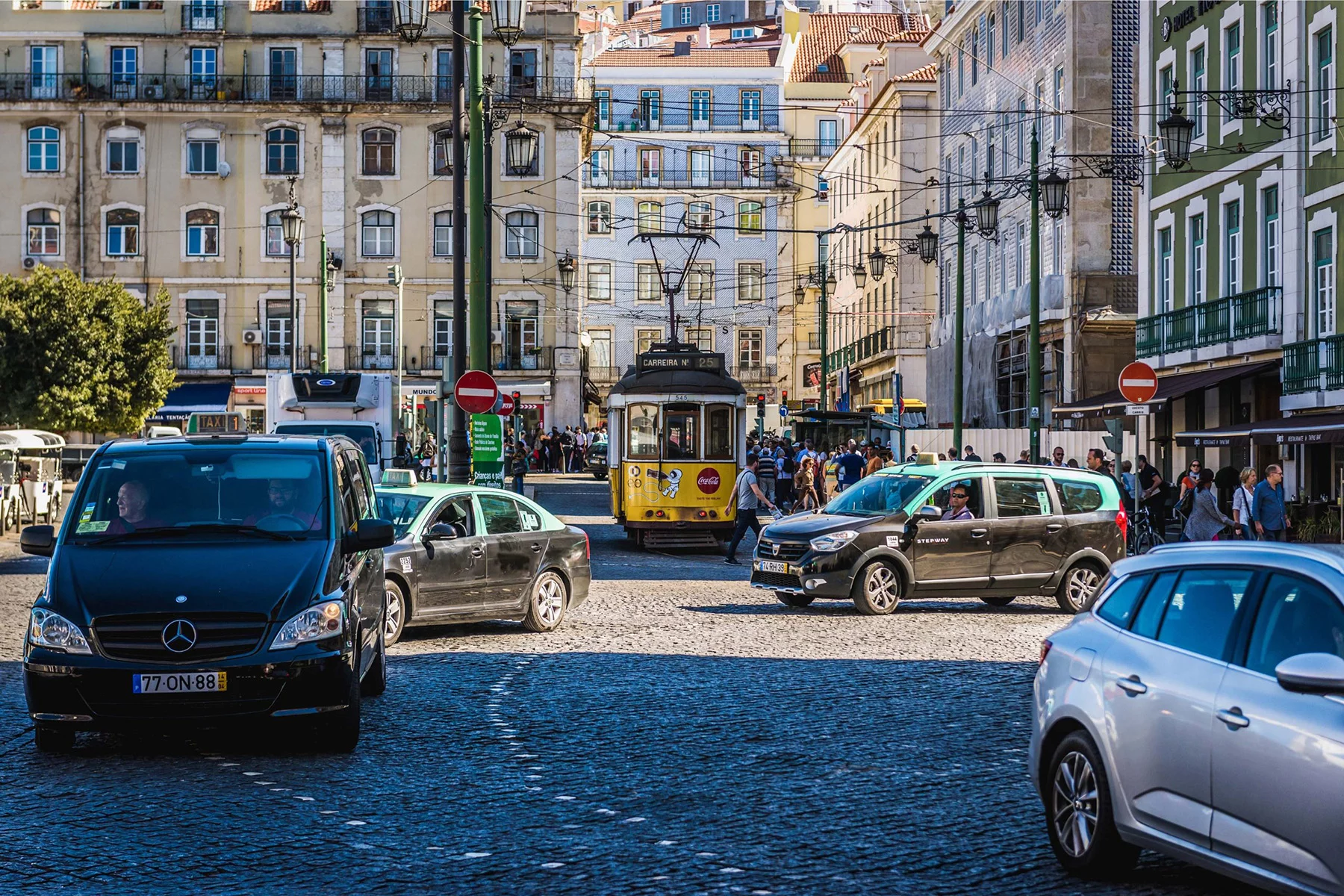 Cars and trams on a busy street in Lisbon