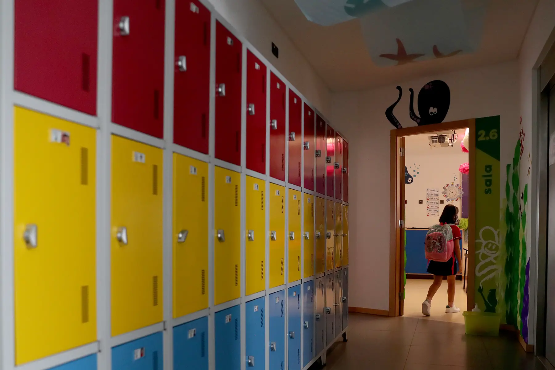 Child enters an elementary school classroom in Paço de Arcos, Portugal