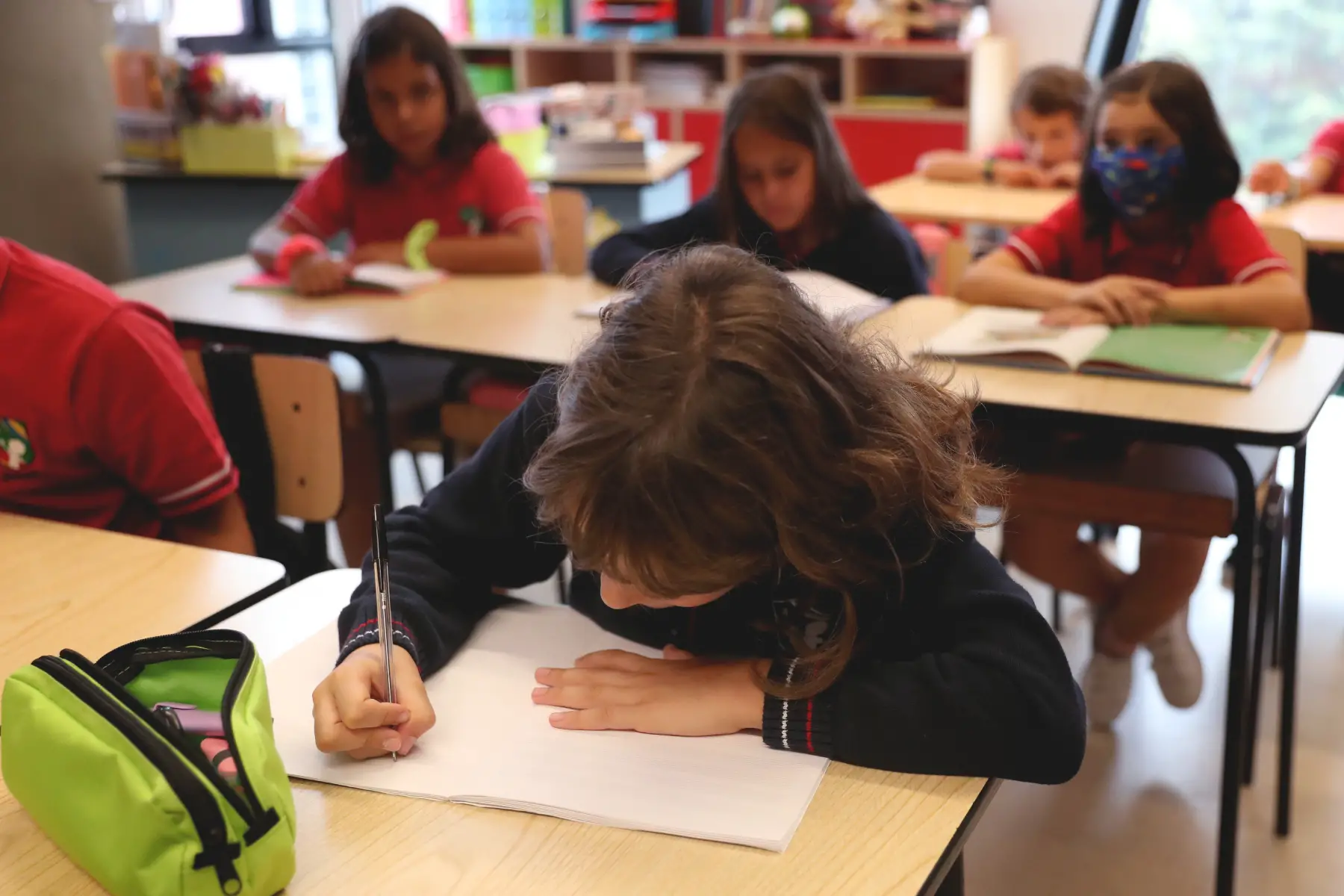 Children in a classroom in Portugal, writing at desks
