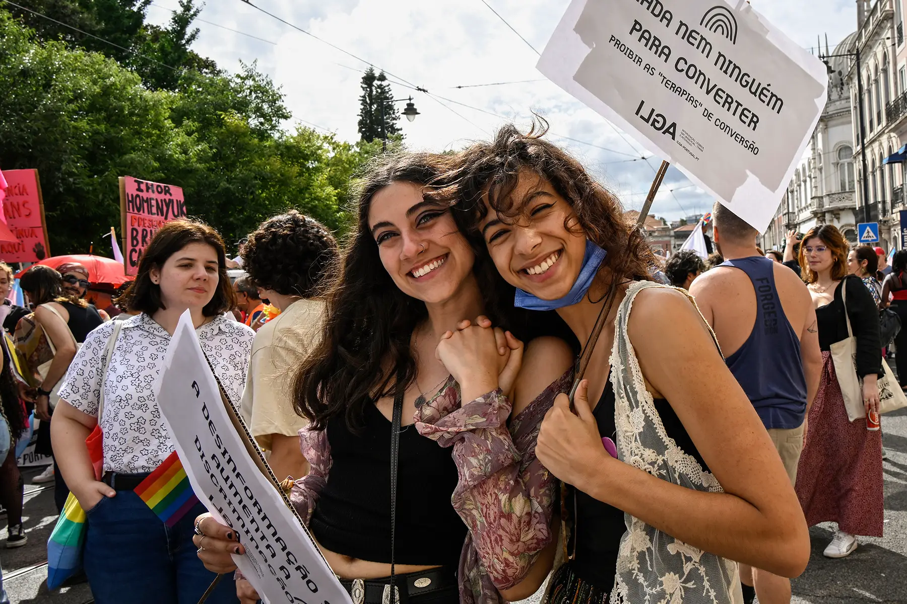 A couple holding hands at Pride in Lisbon