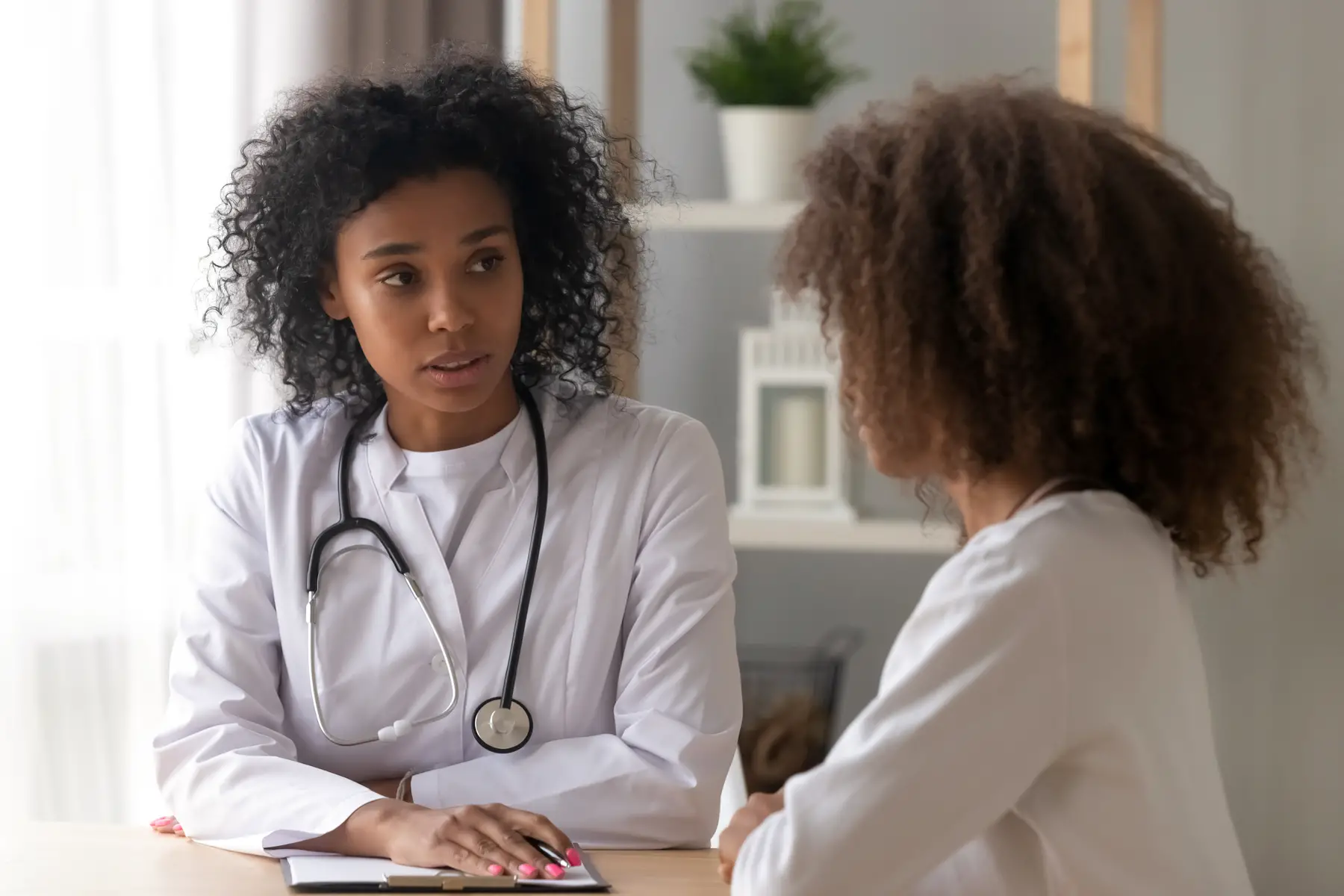 a young woman having a consultation with a doctor