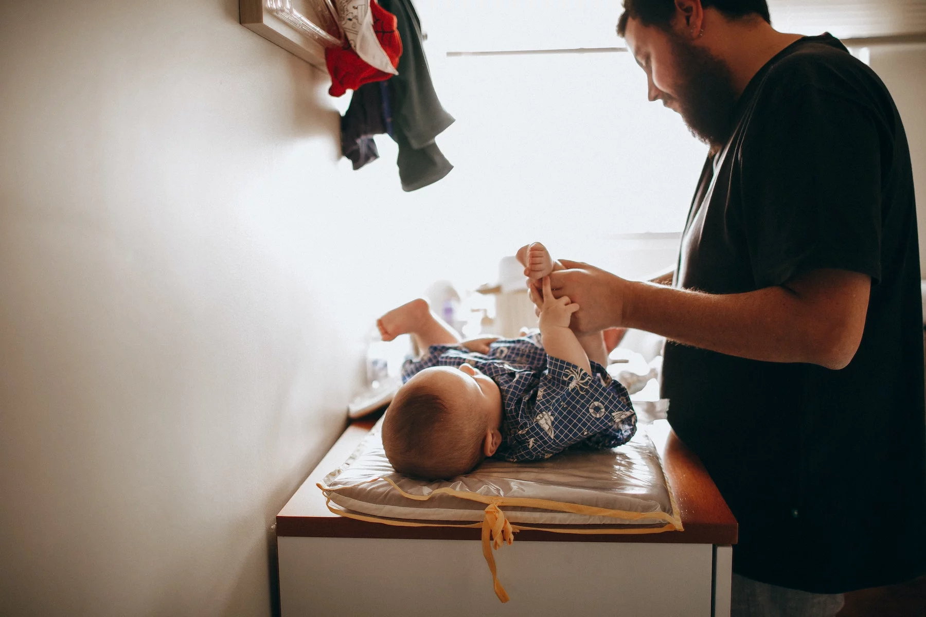 Father changing diaper of newborn