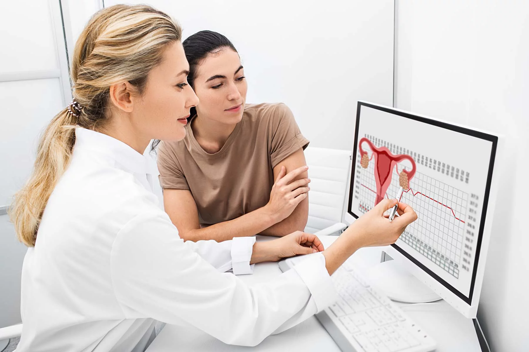 gynecologist showing female patient information on screen