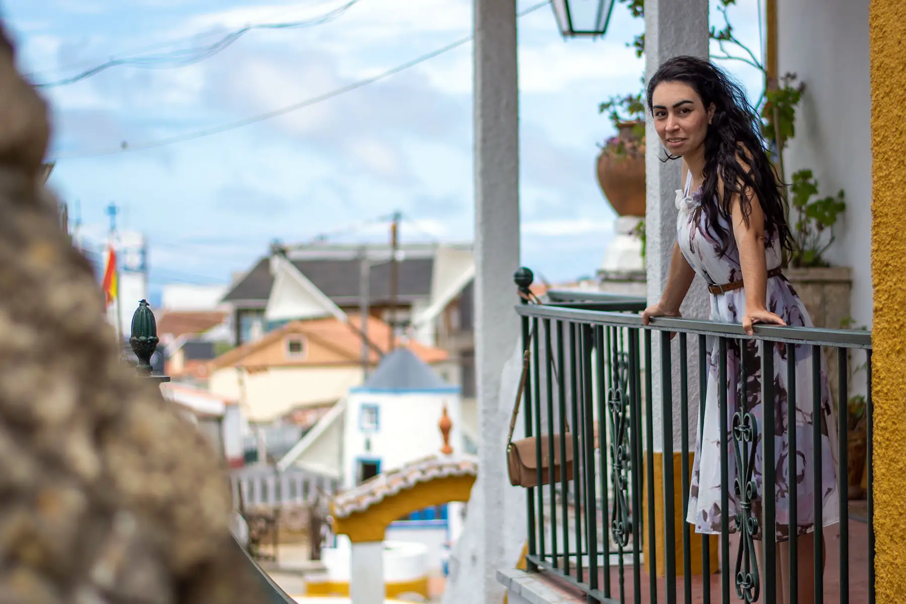 Woman standing on a porch in the village of Sobreiro, near Lisbon.