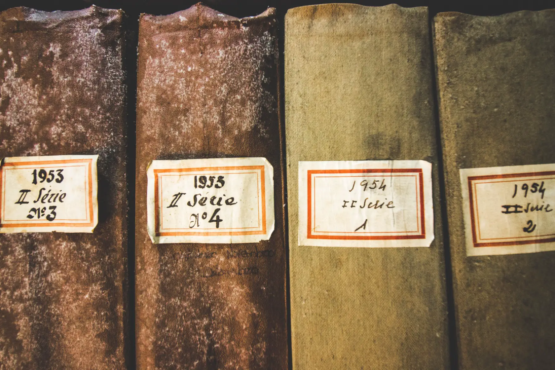 A close-up of a collection of four old books from the 1950s which are stored in one of Portugal’s National Archives