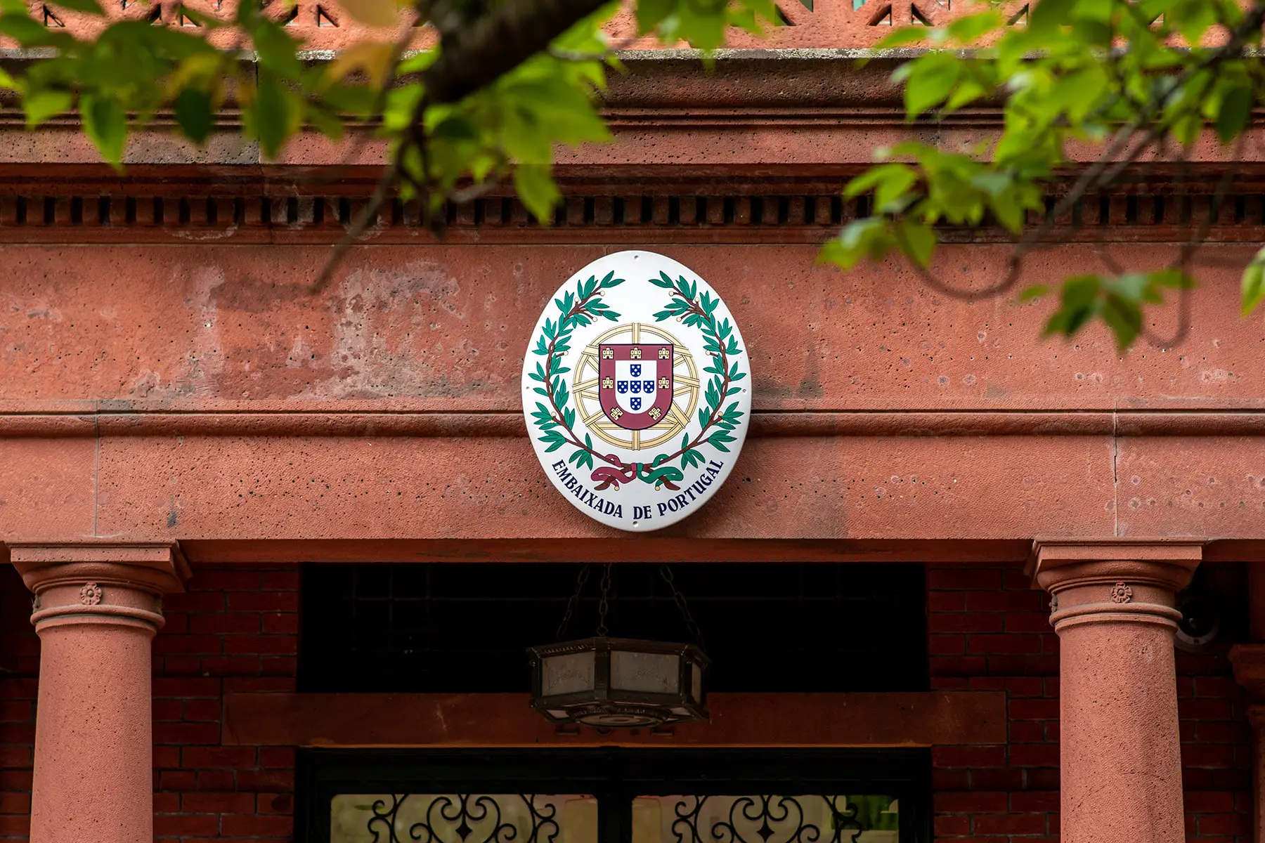 Official logo hanging atop a Portuguese embassy