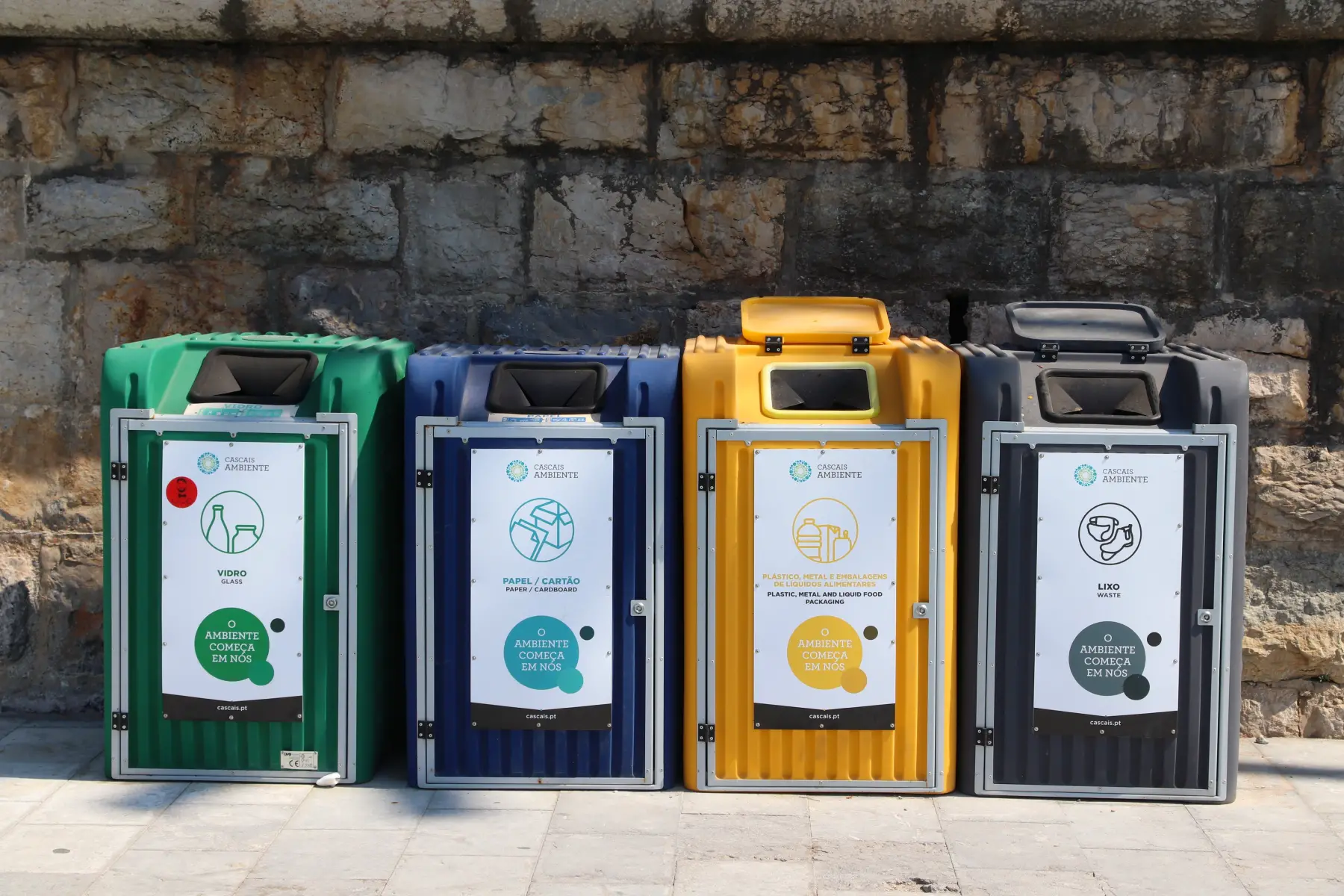 Four large recycling bins
