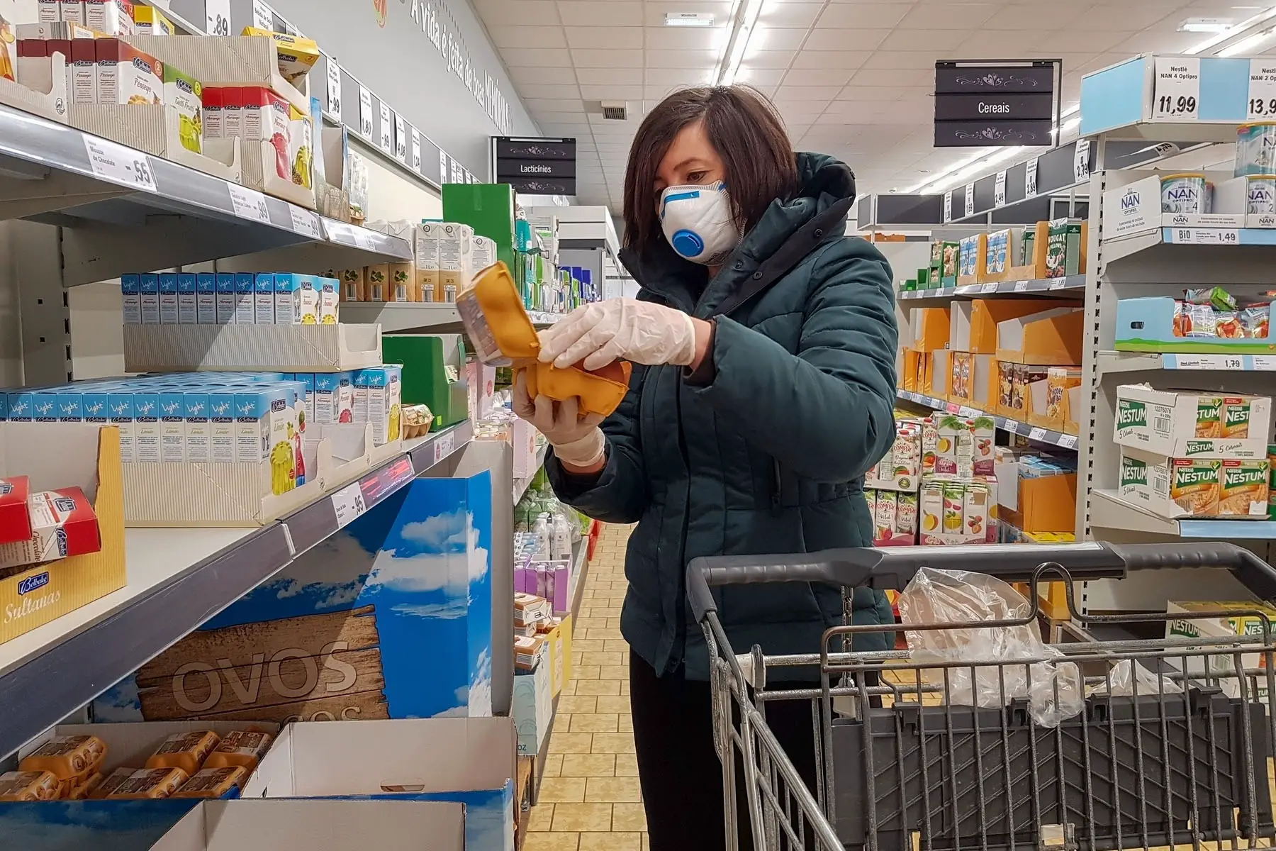 covid restrictions: a woman with a face mask at a supermarket in Faro, Portugal