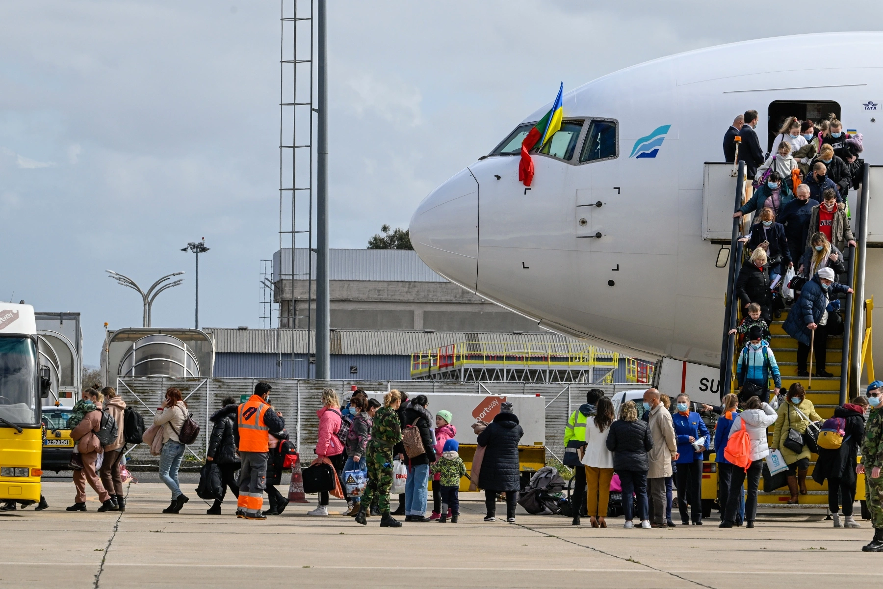Ukrainian refugees disembark plane at Figo Maduro Military Airport 