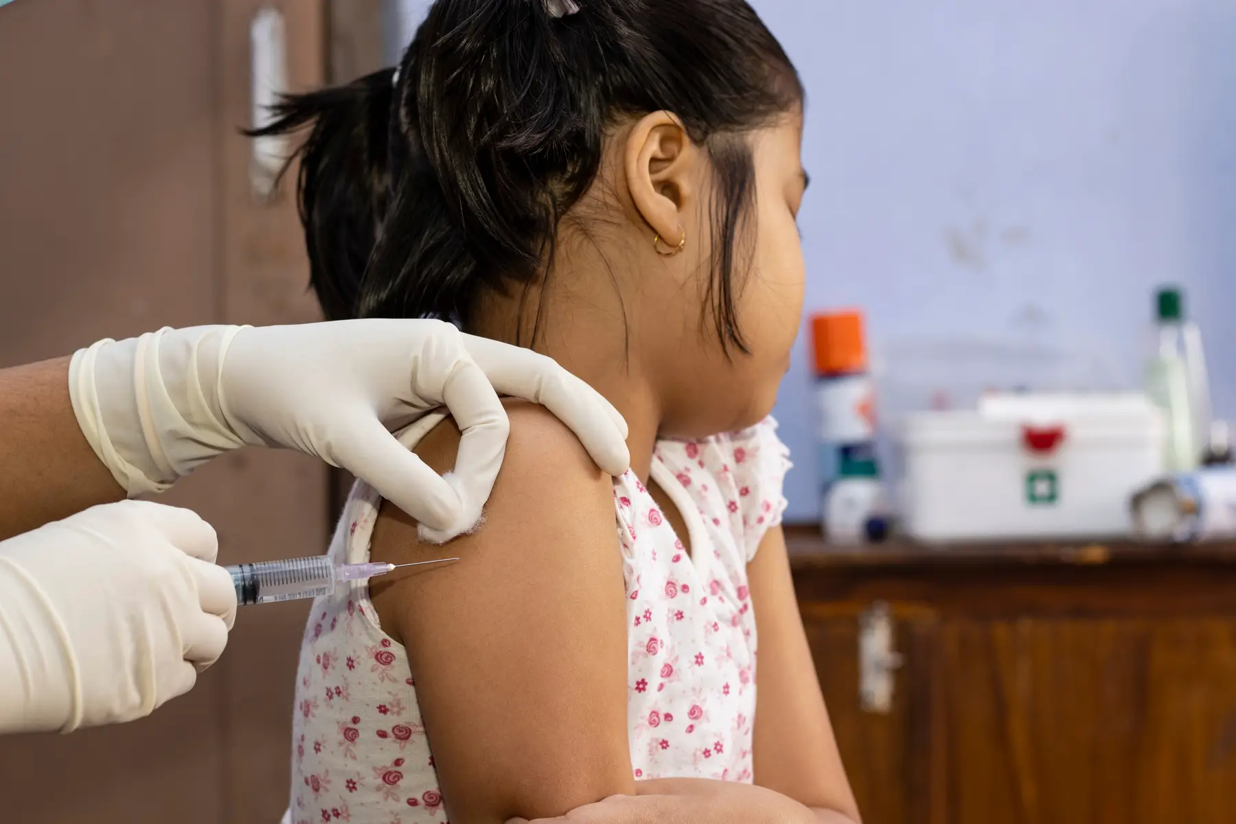 a child being vaccinated by a nurse