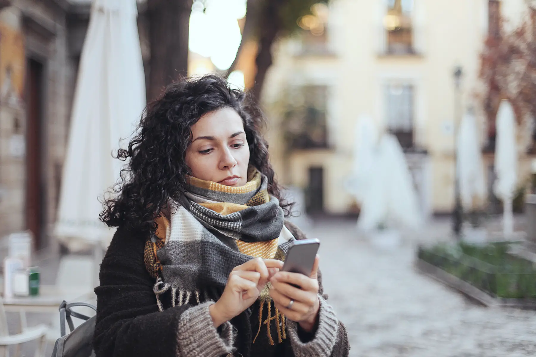 Woman using her smartphone in a city in Portugal