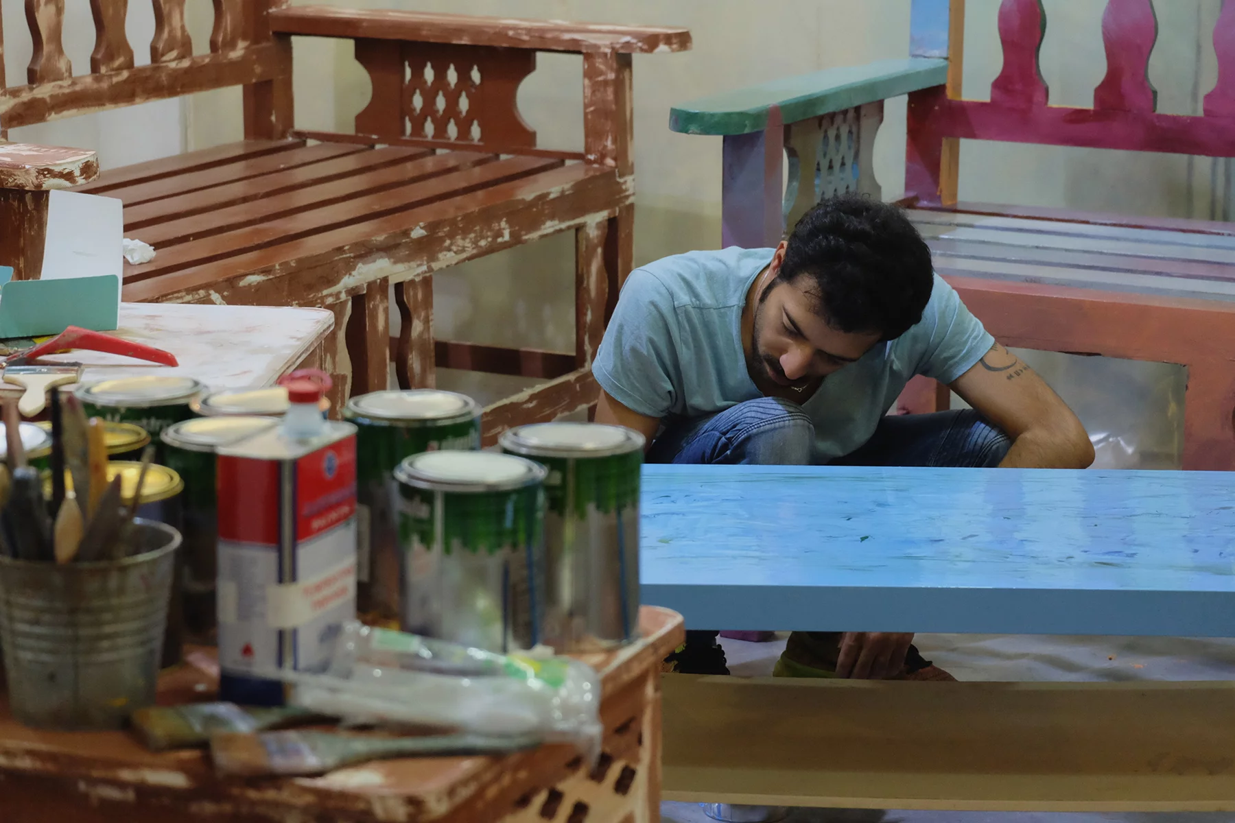 An artist restoring furniture in Doha, Qatar