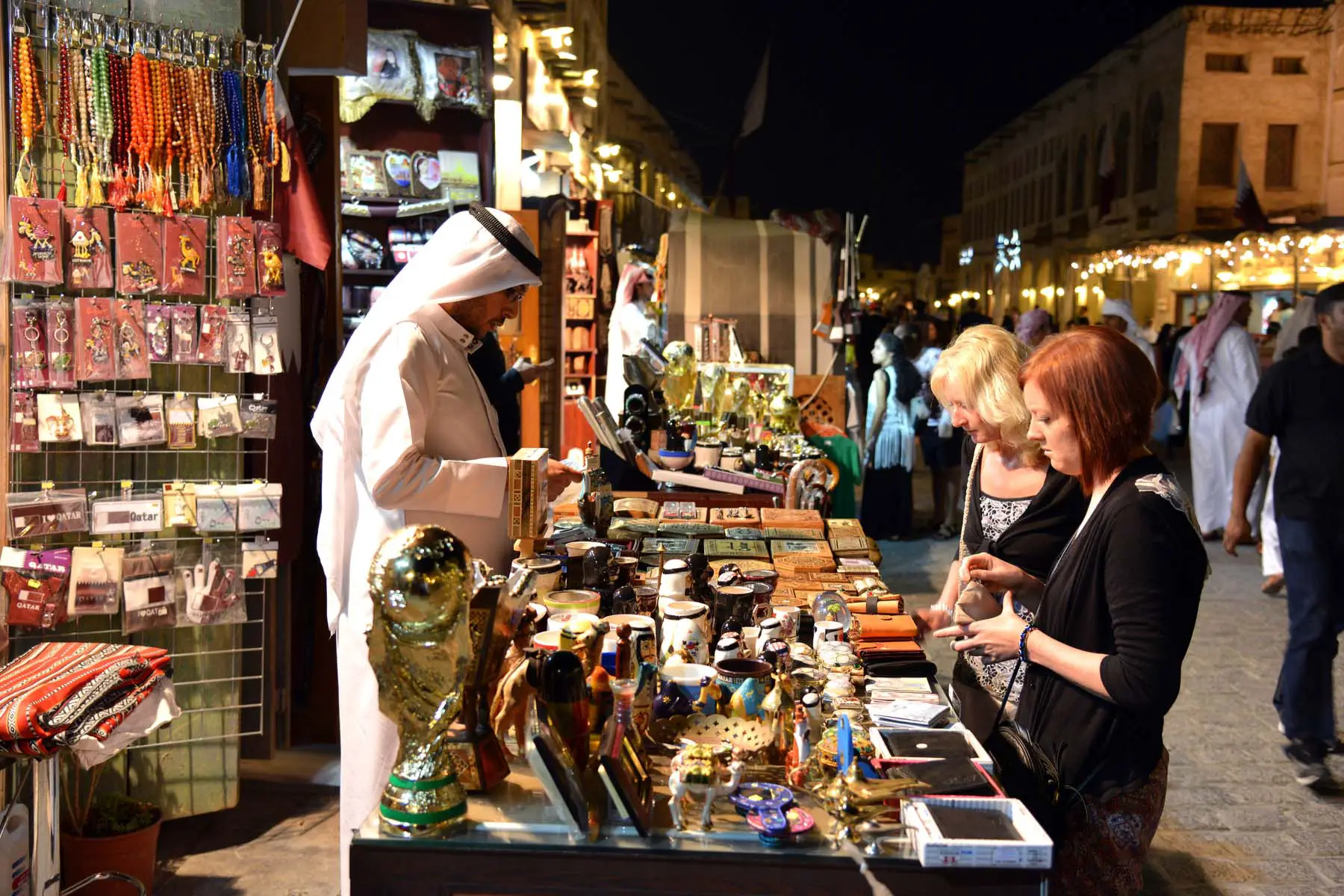 Foreigners buying things at a souk in Qatar