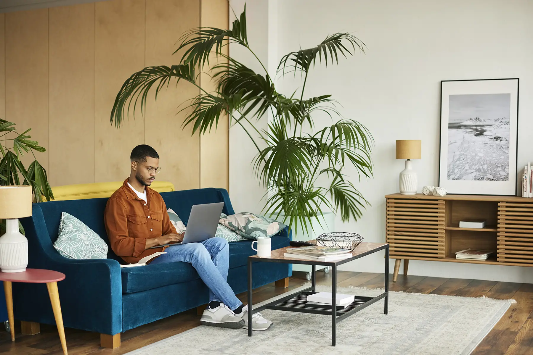 An entrepreneur using his laptop while sitting on a couch