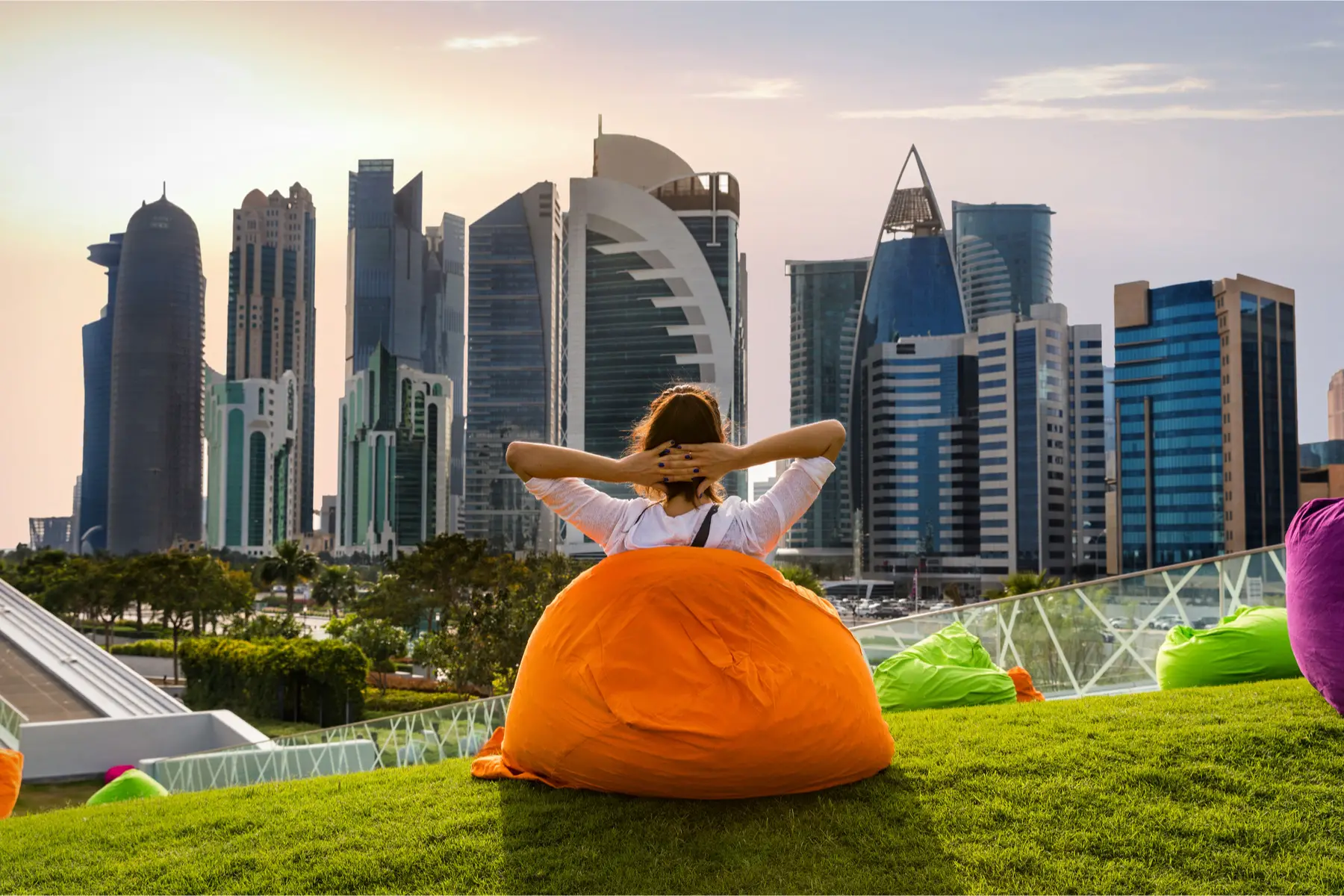 expat woman lounging on a bean bag in a Doha park
