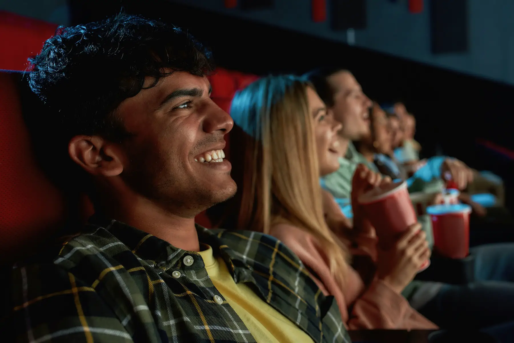 A group of friends laughing at a cinema
