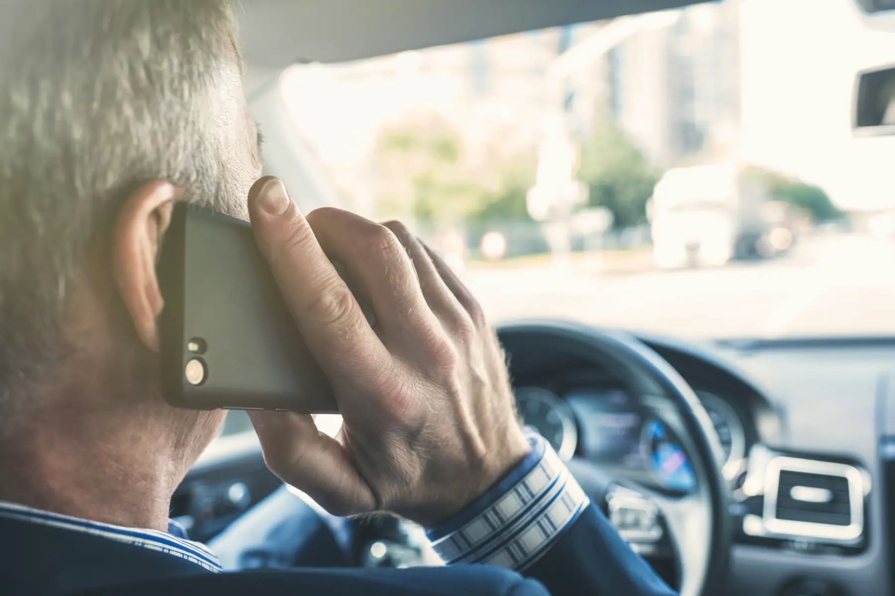 Man using his mobile phone while driving