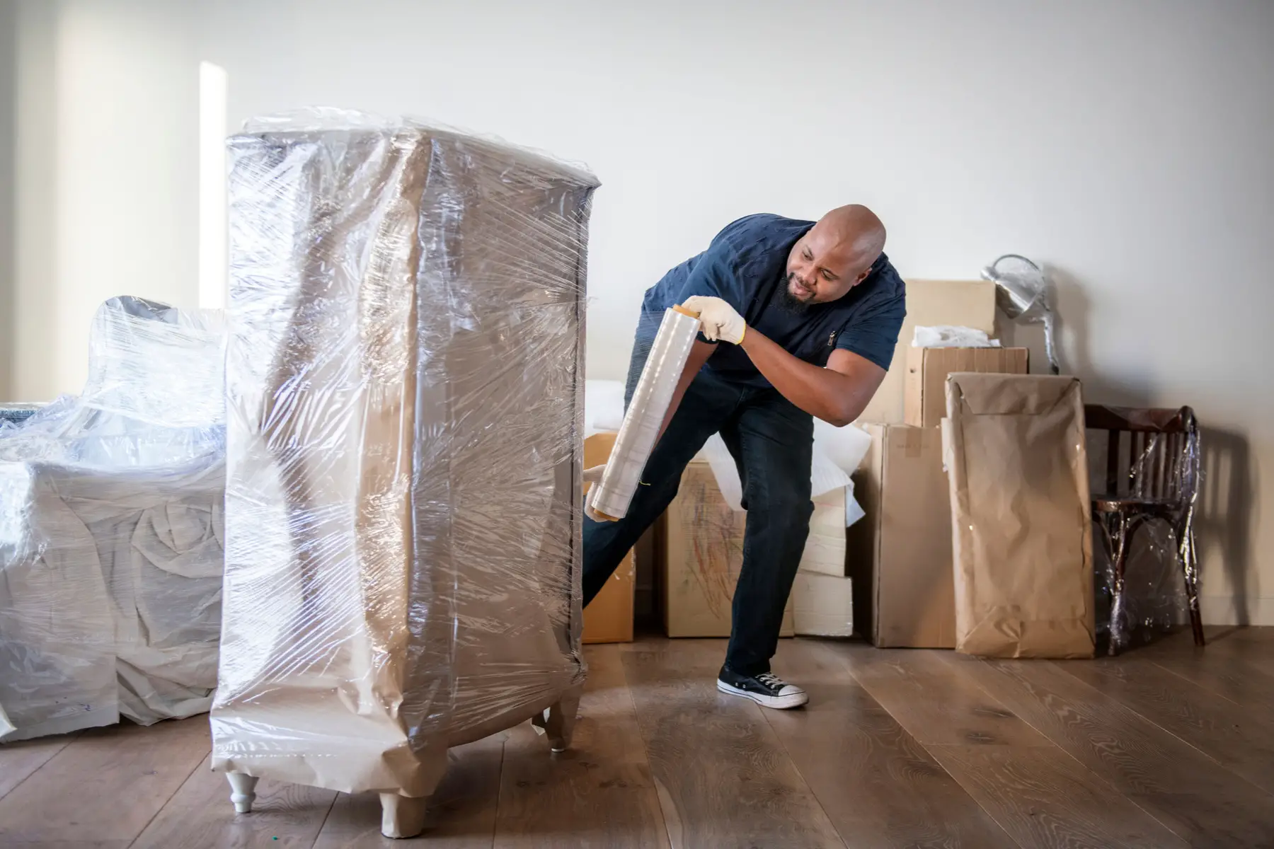 A professional mover packing belongings for transport