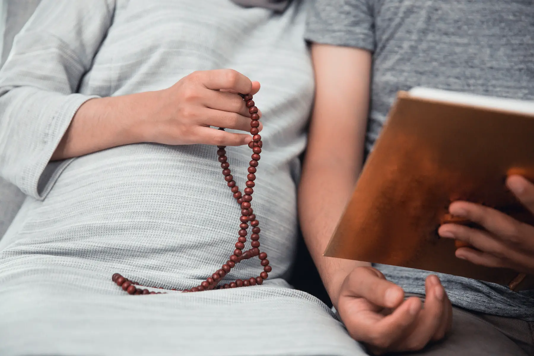 Pregnant Muslim woman reading the Quran