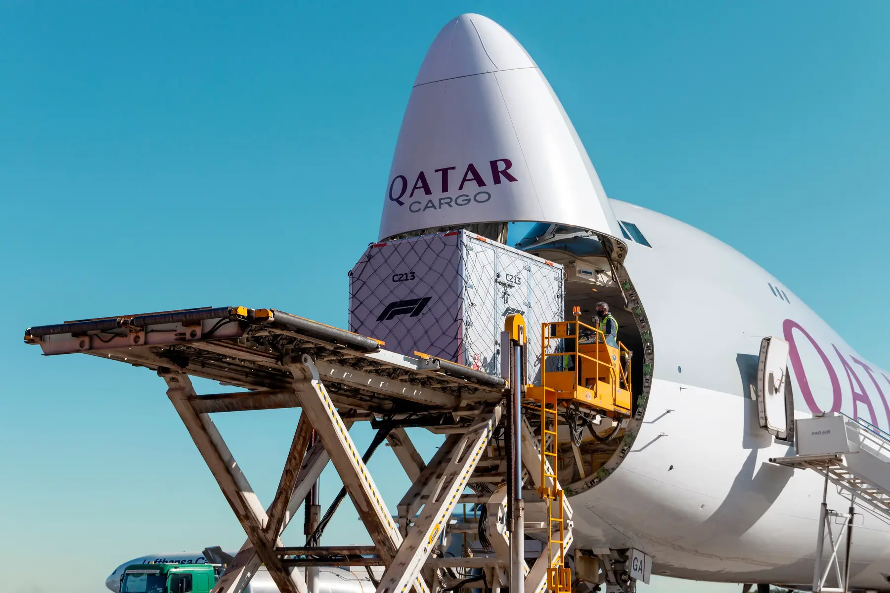 a Qatar Cargo plane being loaded with freight
