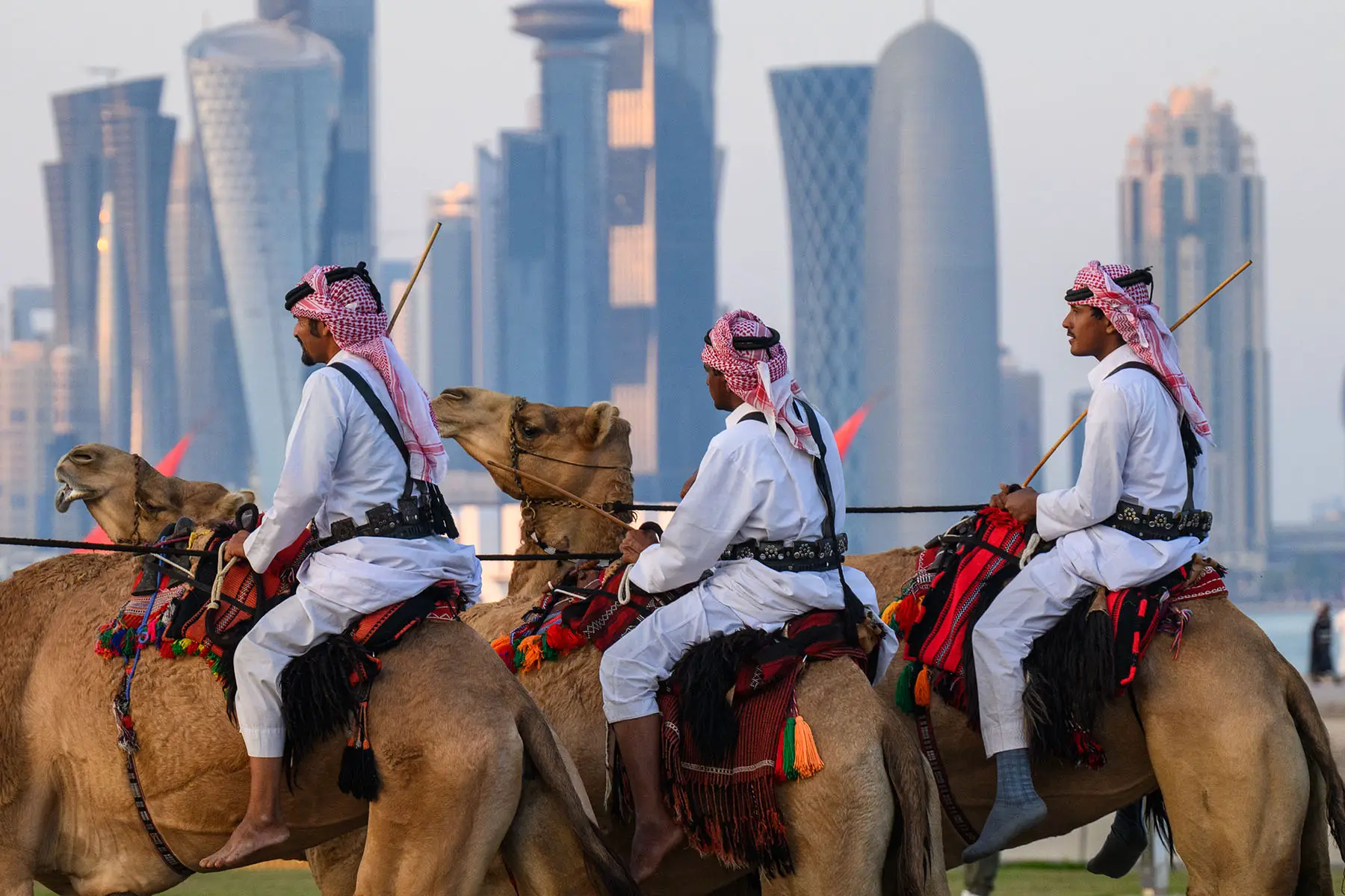 Mounted security forces ride their camels along the Corniche beach promenade.