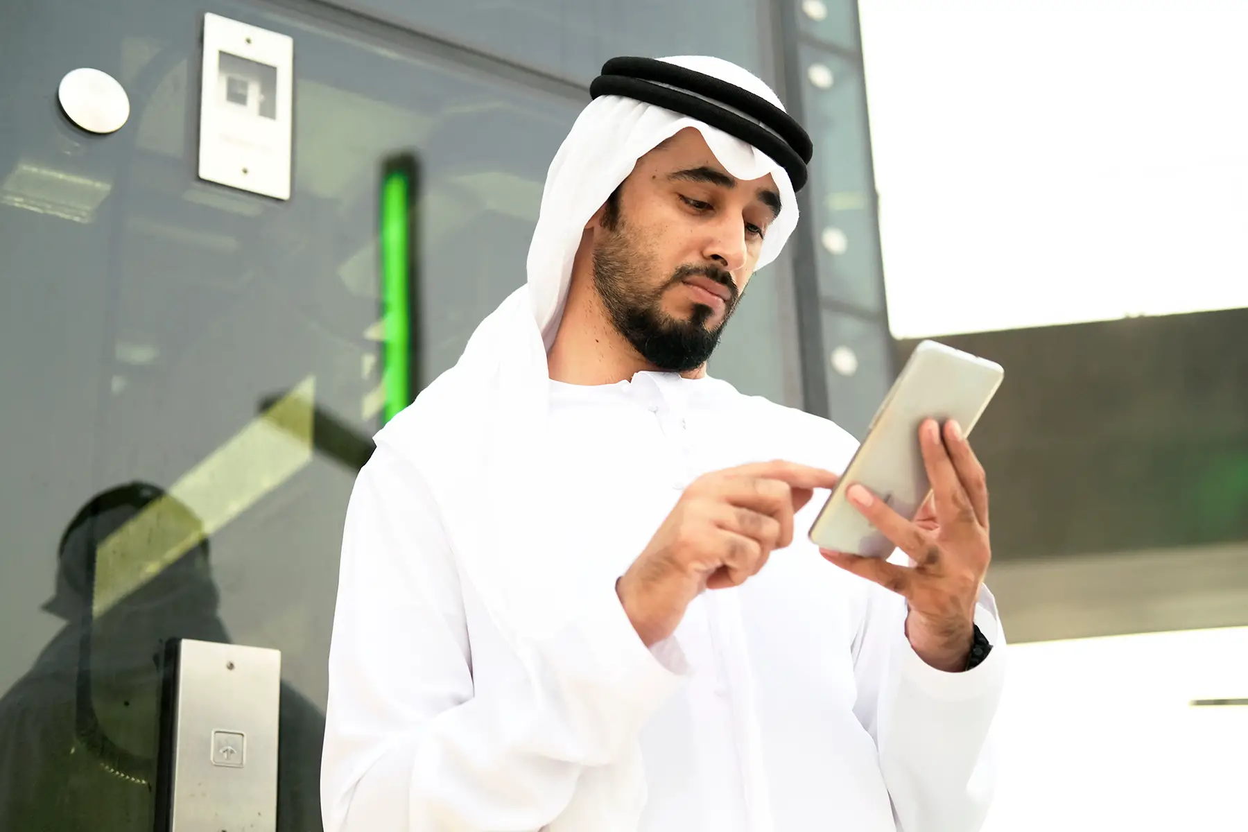 Qatari man using his mobile phone