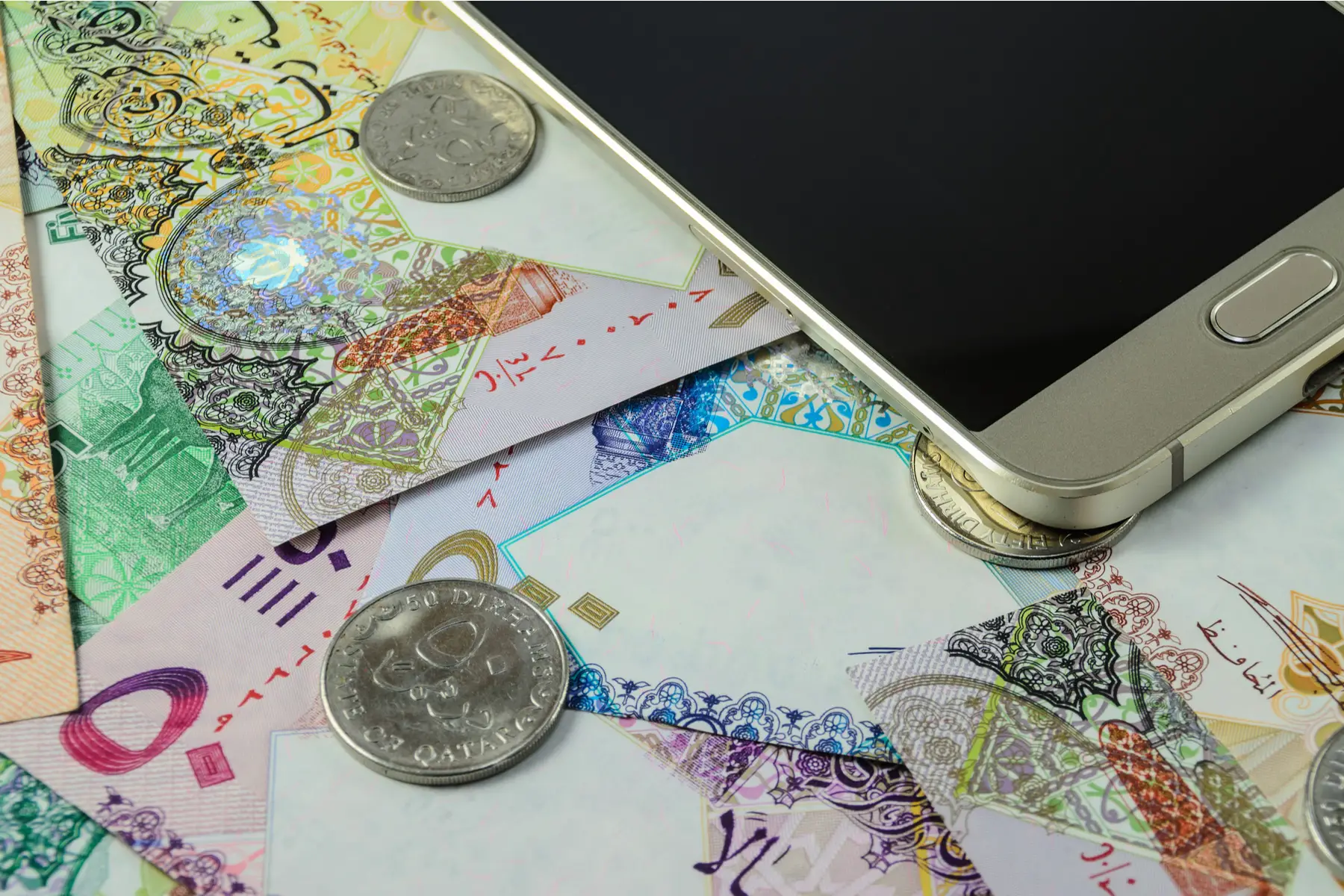 Qatari money and a mobile phone