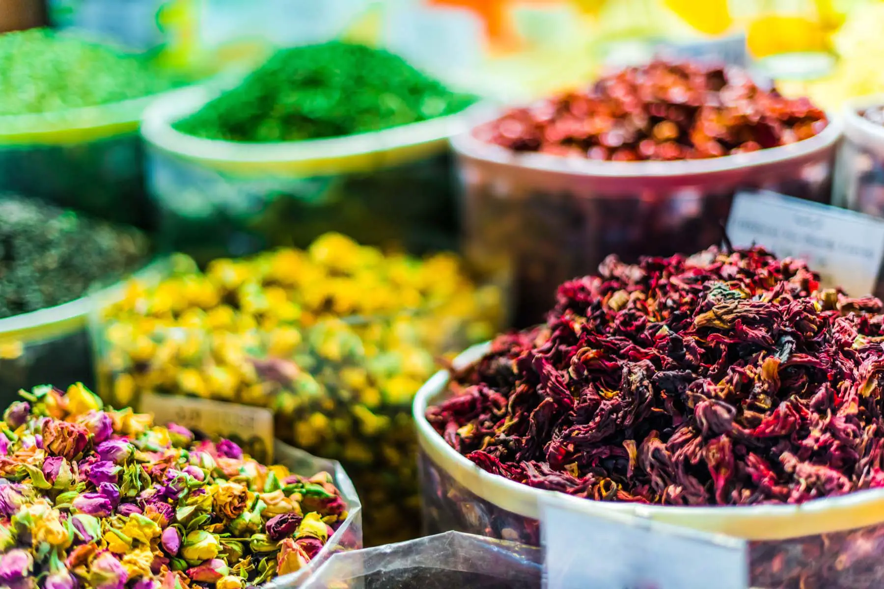 Bowls of colorful spices in Qatari marketplace