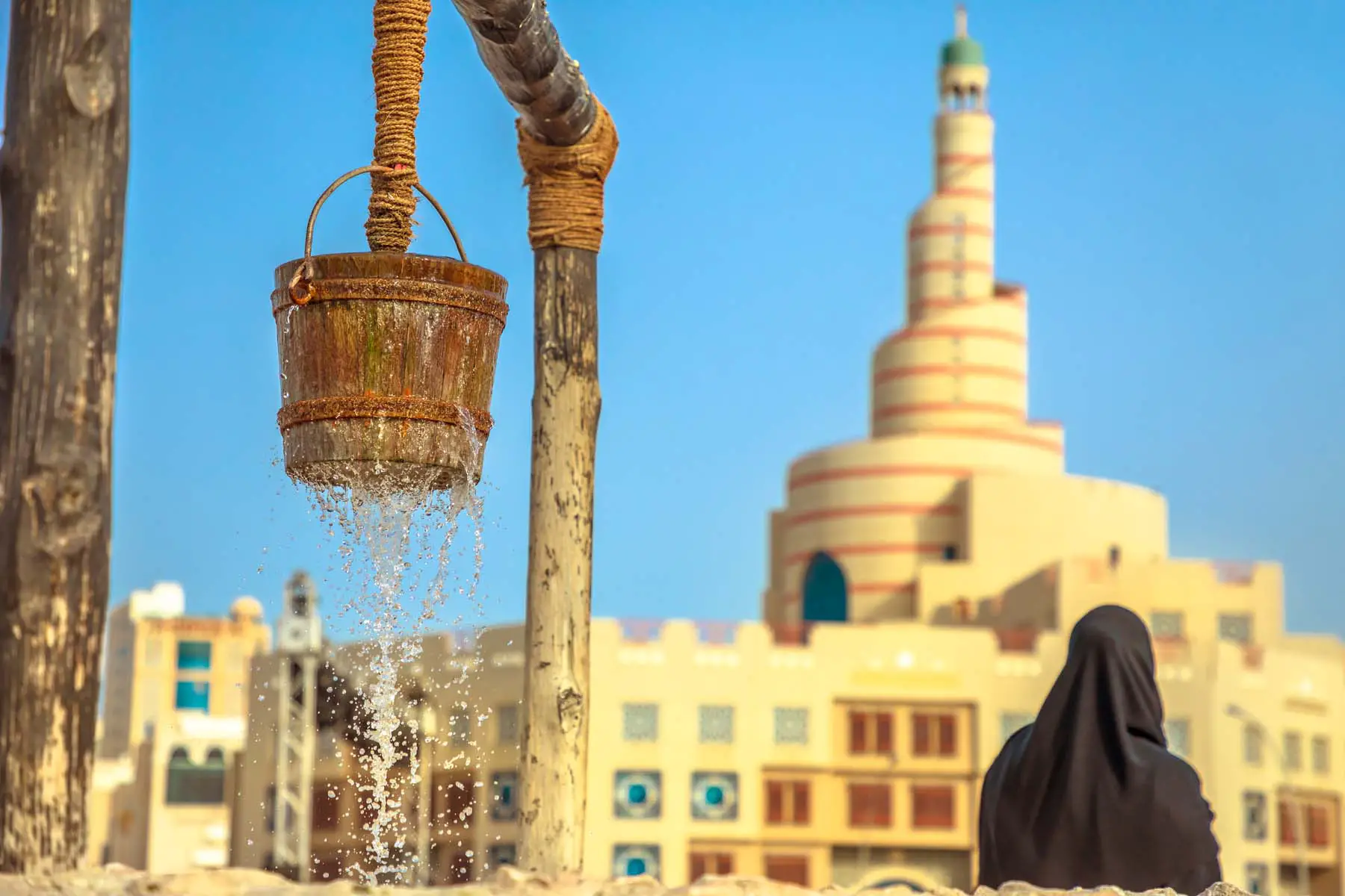 A bucket overflowing with water at a Qatari well