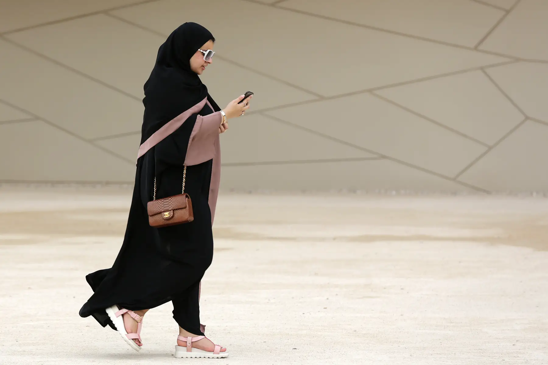 Woman using her smartphone in Doha, Qatar
