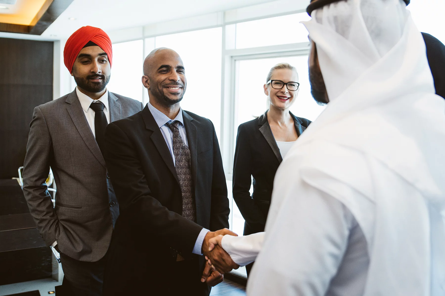 Work colleagues sharing a handshake in Qatar