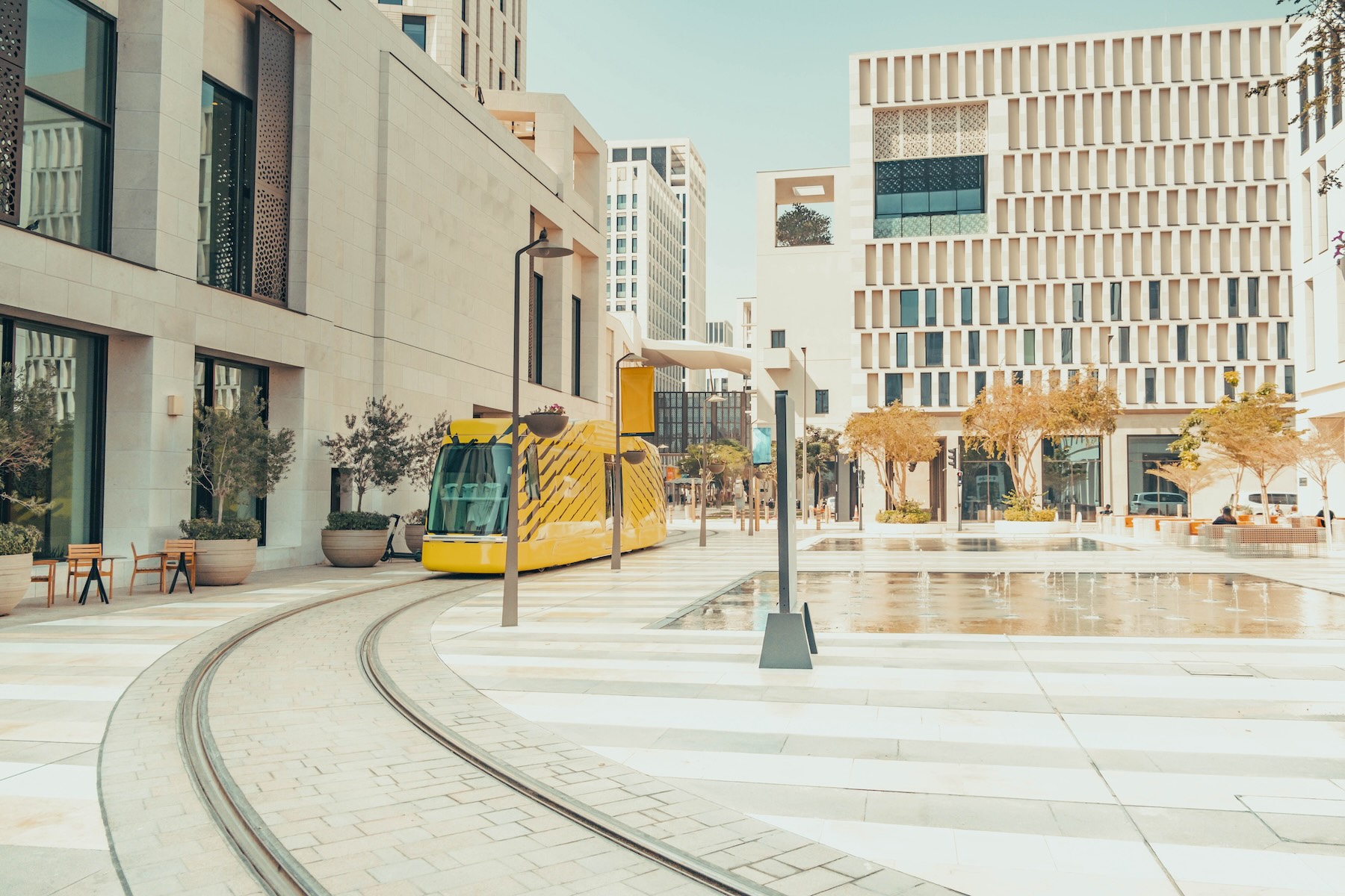 A tram drives down an empty street in Doha, Qatar