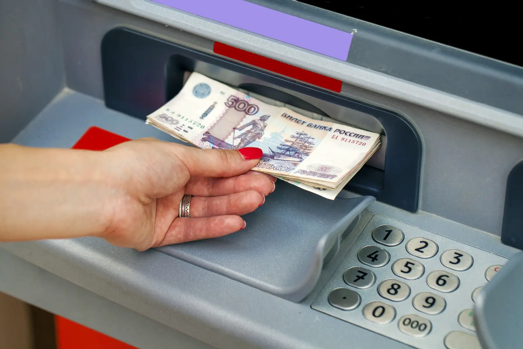 Russian bank account, woman using cash machine in Russia