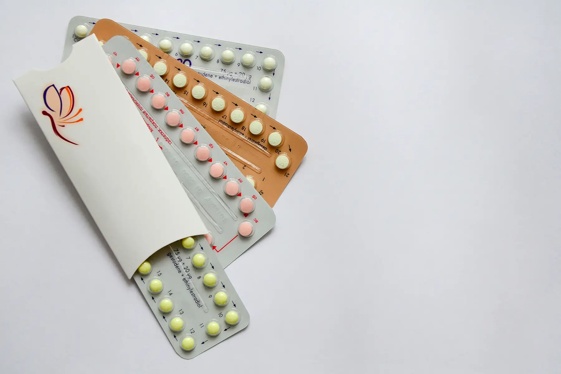 Birth control pills in pastel-colored blister packs
