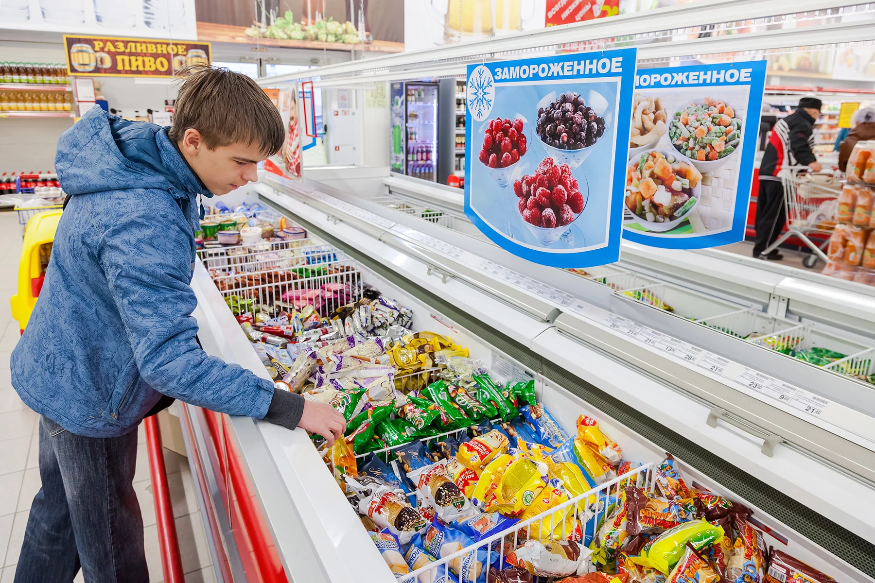 A boy choosing ice cream in a supermarket in Samara