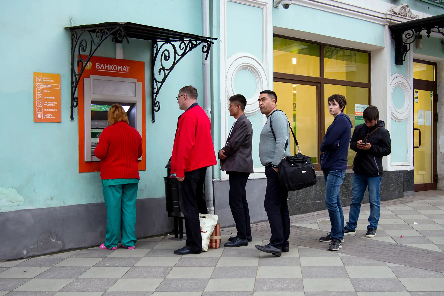 Customers queueing at an ATM in Moscow, Russia